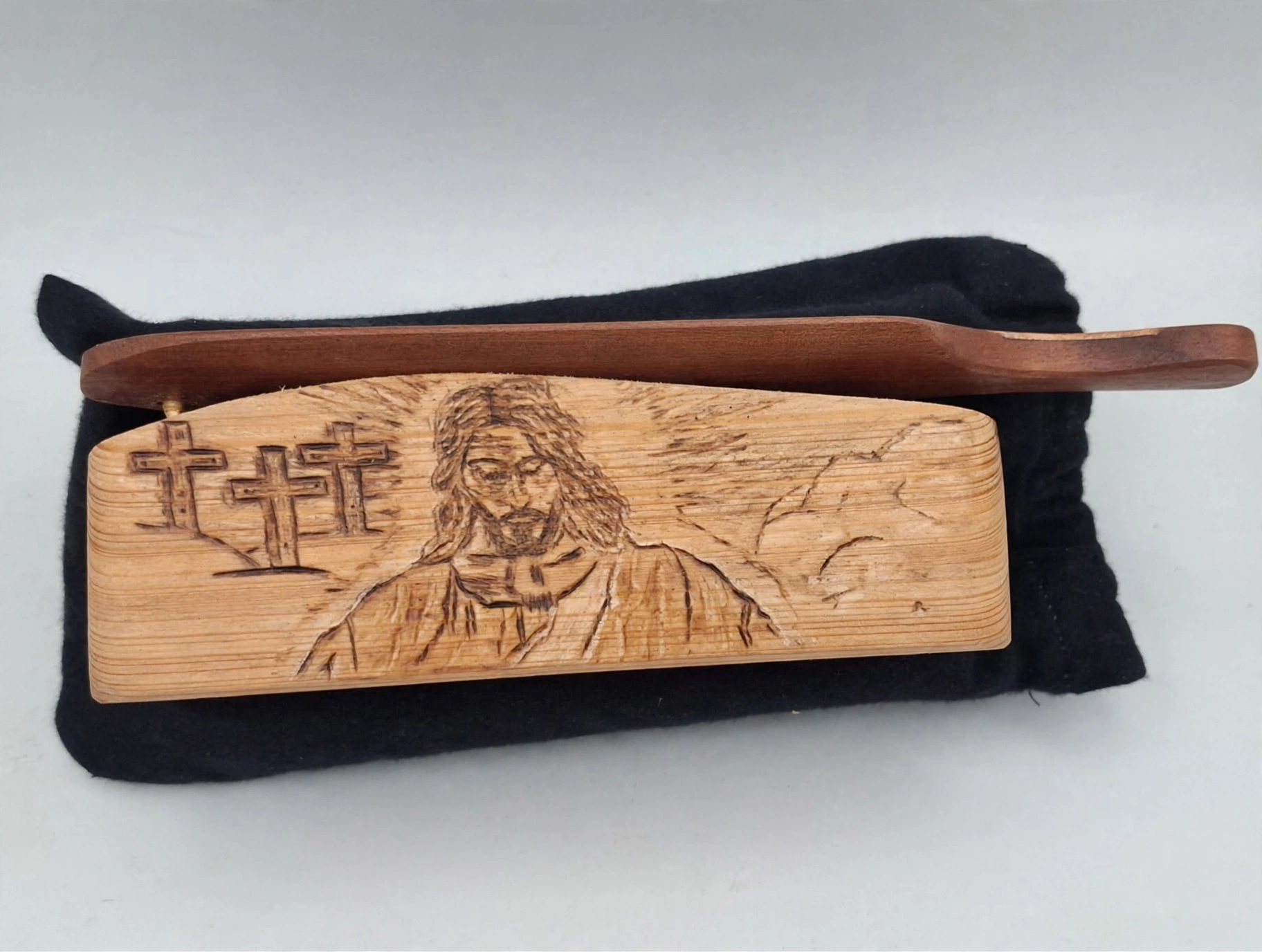 Hand-carved wooden box call with Jesus and the three crosses of Calvary burned into the lid